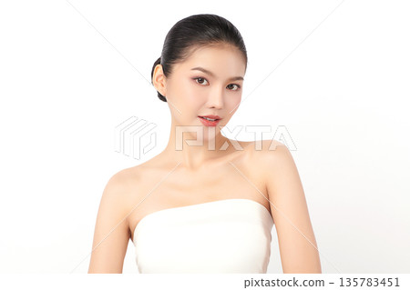 A beautiful young Asian woman with clean, fresh skin against a white background. Skincare, facial treatment, cosmetology, beauty, and spa. An elegant portrait of an Asian woman. 135783451
