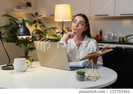 Young woman study on laptop takes notes watches tutorial solves test prepares exams focused evening Young woman study on laptop takes notes watches tutorial solves test prepares exams focused evening 135783462