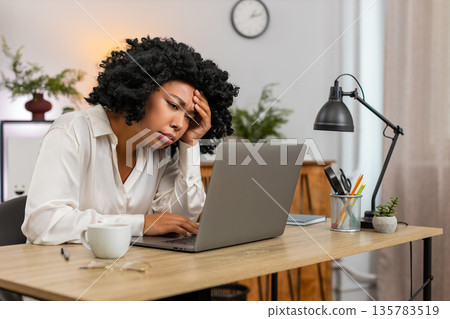 African American businesswoman disappointed sees laptop screen after game loss news client rejection 135783519