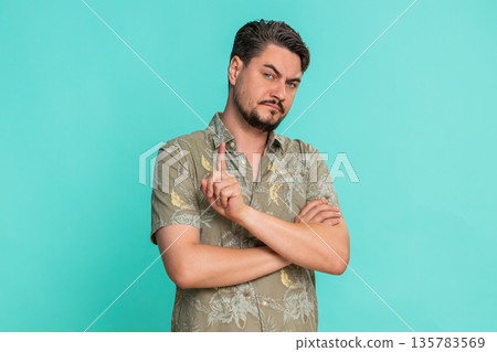 Man crossing arms on chest shaking head expressing disagreement refusal firm negative body language Man crossing arms on chest shaking head expressing disagreement refusal firm negative body language 135783569
