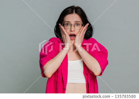 Woman shivering looking around anxiously hugging shoulders expressing fear worry nervous feeling Woman shivering looking around anxiously hugging shoulders expressing fear worry nervous feeling 135783580