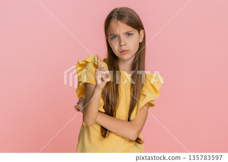 Child girl kid shaking head showing hand gesture no, expressing refusal or disapproval emotionally Child girl kid shaking head showing hand gesture no, expressing refusal or disapproval emotionally 135783597