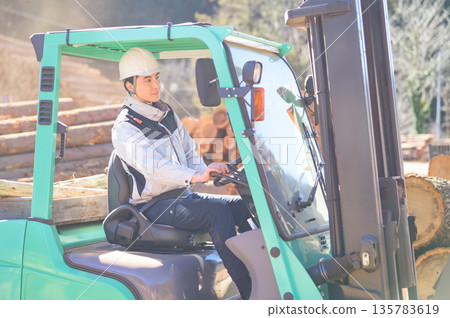 Japanese man driving a forklift. Photo courtesy of Tama Forest Center Cooperative Association. Japanese man driving a forklift. Photo courtesy of Tama Forest Center Cooperative Association. 135783619