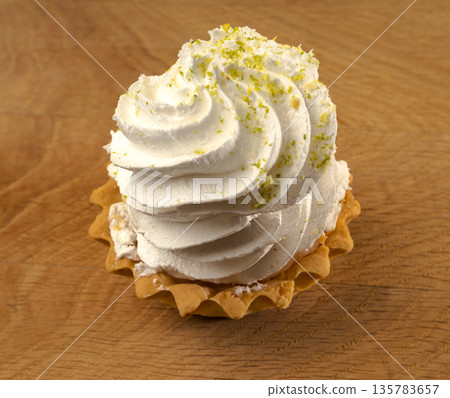 Cake, confection, based on protein cream, on a wooden board Cake, confection, based on protein cream, on a wooden board 135783657