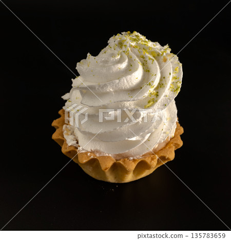 Cake, confectionery, based on protein cream, on a black background Cake, confectionery, based on protein cream, on a black background 135783659