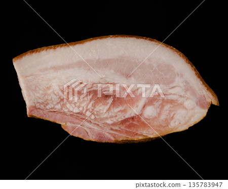 A thick piece of ready-made appetizing, smoked, lard with layers of meat on a black background in isolation A thick piece of ready-made appetizing, smoked, lard with layers of meat on a black background in isolation 135783947