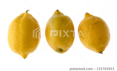 Three whole ripe lemons in a peel, on a white background, isolated 135783953