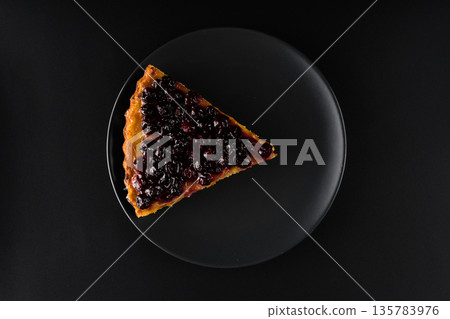 Piece of pie with carrots and currants sprinkled on top on black background f isolation 135783976