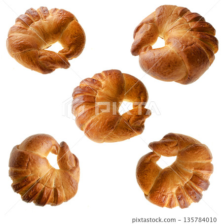 Confectionery, collage, ruddy bun in the shape of a donut, on a white background in isolation 135784010