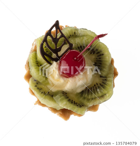 Dessert, cake with kiwi and cherries, on a white plate isolated Dessert, cake with kiwi and cherries, on a white plate isolated 135784079