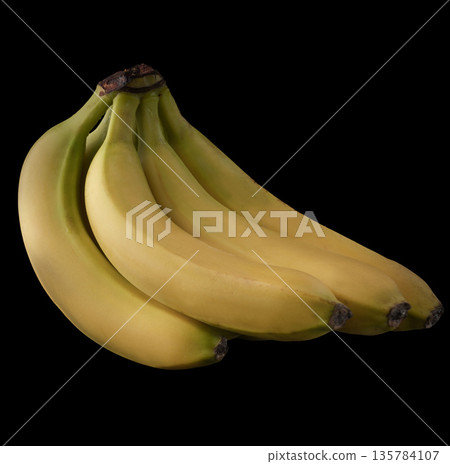 A bunch of several ripe bananas, on a black background, isolated 135784107