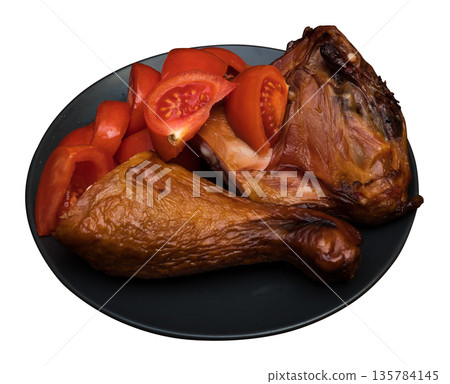 Chicken meat and tomatoes on a black plate, on a white background in isolation Chicken meat and tomatoes on a black plate, on a white background in isolation 135784145