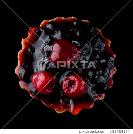 Pastry stuffed with fruits, berries and citrus fruits on a black background in isolation, view from the top, confectionery product 135784154