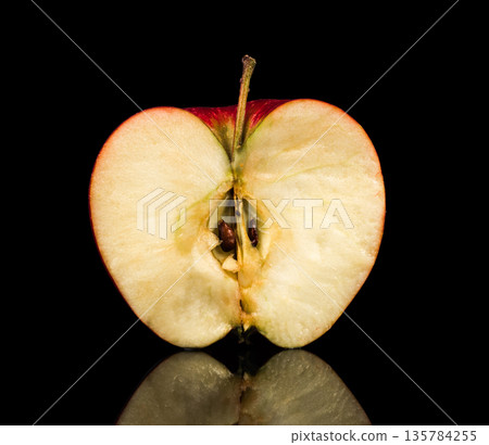 Half cut apple on black background with reflection Half cut apple on black background with reflection 135784255