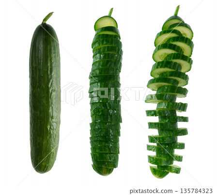 Fresh cucumber covered with chunks on white background isolated Fresh cucumber covered with chunks on white background isolated 135784323