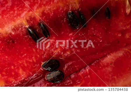 Ripe watermelon pulp and watermelon seeds, close up Ripe watermelon pulp and watermelon seeds, close up 135784438