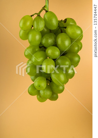 Grapes of white filling, with large sponges on a yellow background Grapes of white filling, with large sponges on a yellow background 135784447