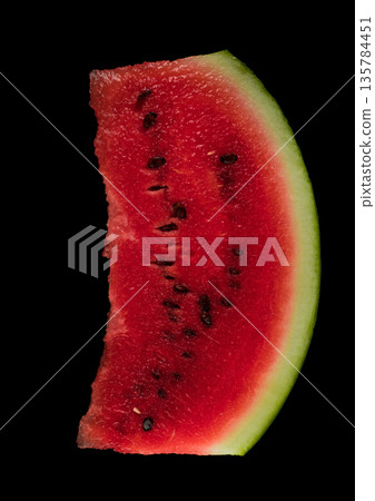 One skibble of ripe watermelon on a black background isolated One skibble of ripe watermelon on a black background isolated 135784451