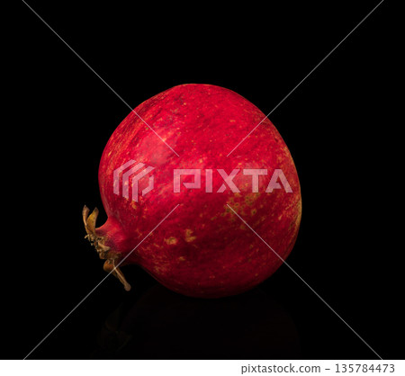 Pomegranate, citrus fruit on a black background with reflection Pomegranate, citrus fruit on a black background with reflection 135784473