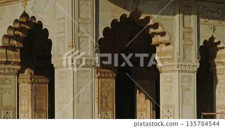 Red Fort Mughal arches and marble columns with dramatic shadow light contrast architectural detail 135784544