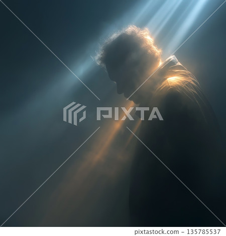 Silhouette of woman in light ray leaving darkness. Female silhouette standing in a beam of light, symbolizing hope and new beginnings 135785537