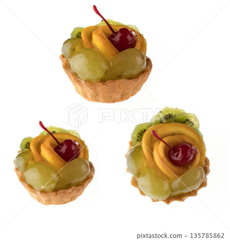 Dessert, fruit cake, with cherry grapes and orange slices on a white background in isolation, collage Dessert, fruit cake, with cherry grapes and orange slices on a white background in isolation, collage 135785862