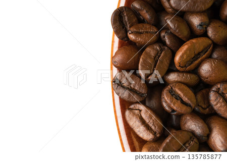 coffee grains in a cup, close-up, on a white background 135785877