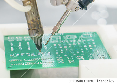PCB Circuit Board Soldering Robot in Automated Electronics Manufacturing PCB Circuit Board Soldering Robot in Automated Electronics Manufacturing 135786189
