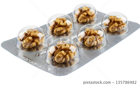 Walnuts packaged like pills in a blister pack for health and nutrition 135786982