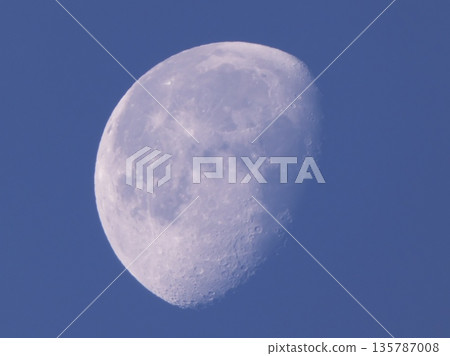 The white moon and clear craters appearing in the blue sky during the day The white moon and clear craters appearing in the blue sky during the day 135787008