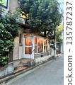 A stylish shop in a back alley at dusk 135787237