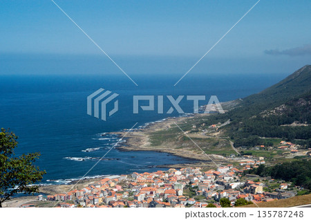 A beautiful blue ocean with a small town in the background 135787248