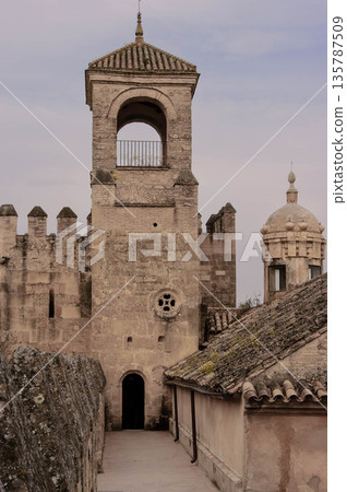 A tall tower with a small window on the top 135787509