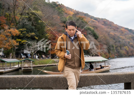 Middle-aged people making phone calls Middle-aged people making phone calls 135787635