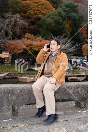 Middle-aged people making phone calls Middle-aged people making phone calls 135787641