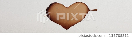 Brown watercolor heart creating organic abstract art. Brown heart shape painted with watercolor on textured white paper showing a drip Brown watercolor heart creating organic abstract art. Brown heart shape painted with watercolor on textured white paper showing a drip 135788211