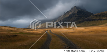 Icelandic valley with impressive green mountains and dramatic sky. Lush green Icelandic valley with rugged mountains under a cloudy sky 135788281