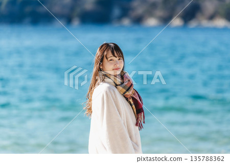 A woman standing by the sea 135788362