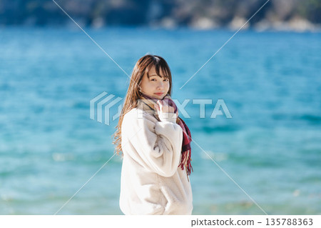 A woman standing by the sea 135788363