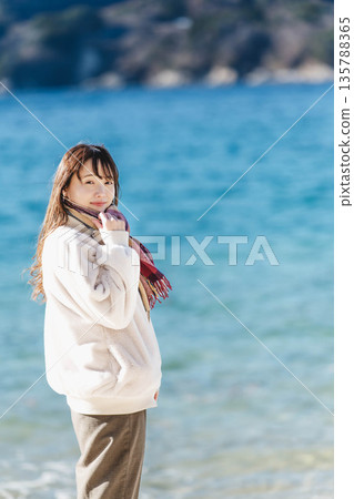 A woman standing by the sea 135788365