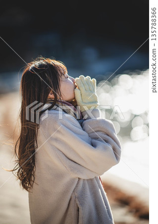 A woman standing by the sea 135788366