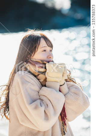 A woman standing by the sea 135788373