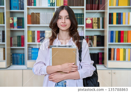 Portrait of teenage female student inside library classroom Portrait of teenage female student inside library classroom 135788863