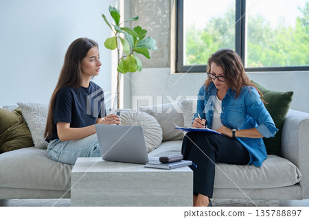 Teenage girl patient in therapy session with social mental therapist Teenage girl patient in therapy session with social mental therapist 135788897