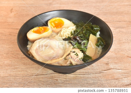 Tonkotsu Chashu ramen orJapanese yellow noodles topping slice braised pork with boiled egg and seaweed in Miso soy sauce on bowl Tonkotsu Chashu ramen orJapanese yellow noodles topping slice braised pork with boiled egg and seaweed in Miso soy sauce on bowl 135788931