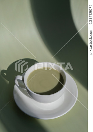 Nutrient-rich matcha drink with trendy deep shadows on soft colored background. Morning beautiful breakfast present gift idea. Vibrant creative colors. Natural energy givers Nutrient-rich matcha drink with trendy deep shadows on soft colored background. Morning beautiful breakfast present gift idea. Vibrant creative colors. Natural energy givers 135789073