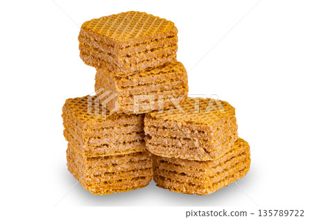Stack of wafer filled with salted caramel flavored cream isolated on white background. Stack of wafer filled with salted caramel flavored cream isolated on white background. 135789722