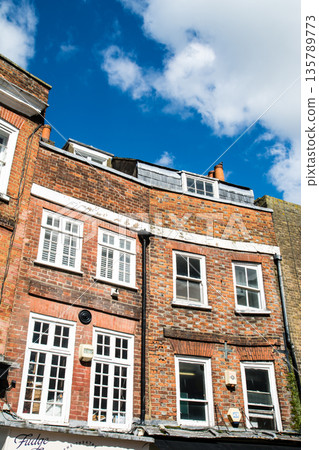 Historic red brick buildings under bright sunlight in Windsor, a suburb of London Historic red brick buildings under bright sunlight in Windsor, a suburb of London 135789773