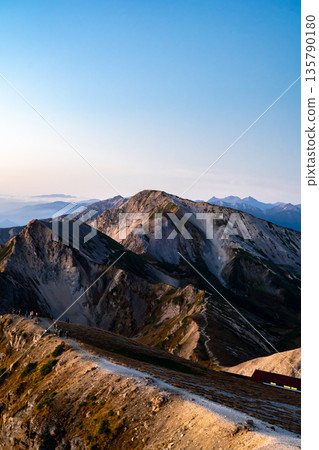Early morning view of Mt. Hakuba-Yari and Mt. Shakushi (Morgenrot) from Mt. Hakuba. Traverse hike from Mt. Hakuba to Mt. Yukikura in the Northern Alps. Early morning view of Mt. Hakuba-Yari and Mt. Shakushi (Morgenrot) from Mt. Hakuba. Traverse hike from Mt. Hakuba to Mt. Yukikura in the Northern Alps. 135790180