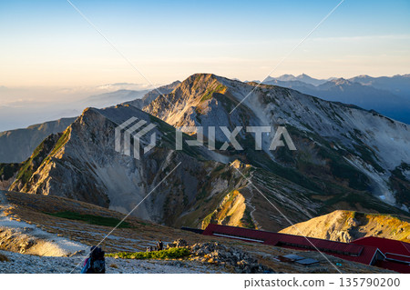 Early morning view of Mt. Hakuba-Yari and Mt. Shakushi (Morgenrot) from Mt. Hakuba. Traverse hike from Mt. Hakuba to Mt. Yukikura in the Northern Alps. Early morning view of Mt. Hakuba-Yari and Mt. Shakushi (Morgenrot) from Mt. Hakuba. Traverse hike from Mt. Hakuba to Mt. Yukikura in the Northern Alps. 135790200